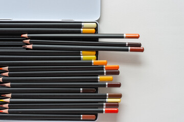 Fototapeta premium dusty color pencils in metal box on paper
