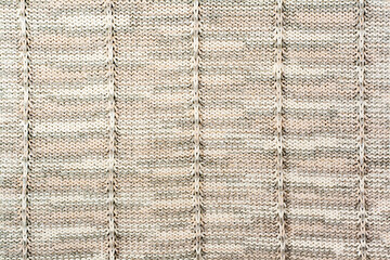 Sweater or scarf fabric texture large knitting. Knitted jersey background with a relief pattern. Wool hand- machine, handmade.