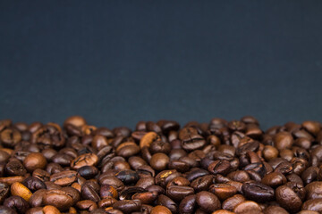 Brown Roasted Coffee Beans Closeup On Dark Background.