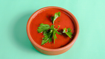 Tomato soup in ceramic pot top view