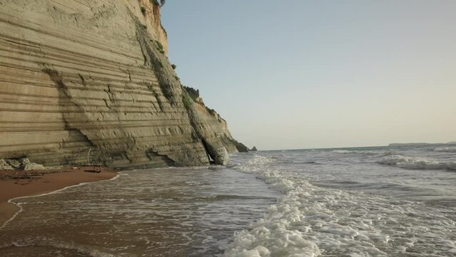 Sea Waves Splashing On Shore By Cliff At Logas Beach
