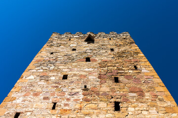 The watchtower against the blue sky.