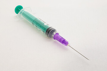 Syringe on white paper