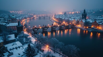 Fototapeta premium Beautiful historical buildings in winter with snow and fog in Prague city in Czech Republic in Europe.