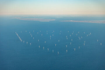 Large wind farm with turbines at sea before Dutch coast, shore of Holland