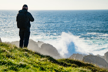 Tourist admiring scenic beauty of Malin Head, Ireland's northernmost point, Wild Atlantic Way,...