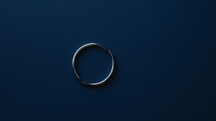 Solitary Silver Ring in Center on Dark Blue Background Wide Angle View