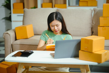 young Asian entrepreneur, the owner of a small clothing store, organizes online live streams...