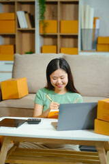 young Asian entrepreneur, the owner of a small clothing store, organizes online live streams...
