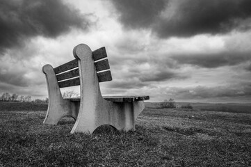 bench in a park with dramatic sky