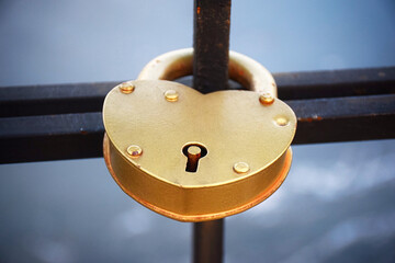 A heart shaped lock connected to other locks near Westminster bridge, Big Ben defocused