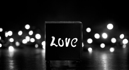 metal love votive with bokeh light background