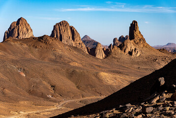 Hoggar landscape in the Sahara desert, Algeria. A view of the mountains and basalt organs that stand around the dirt road that leads to Assekrem. - 738857269