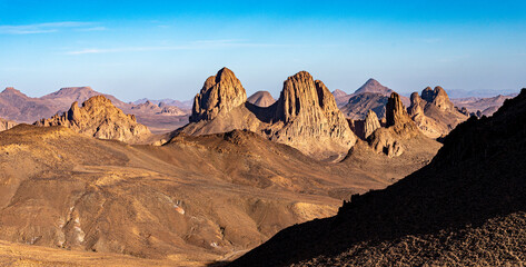 Hoggar landscape in the Sahara desert, Algeria. A view of the mountains and basalt organs that stand around the dirt road that leads to Assekrem. - 738857465