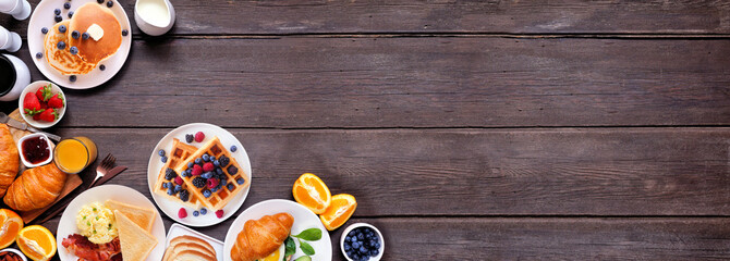 Breakfast or brunch corner border on a dark wood banner background. Top view. Variety of sweet and...