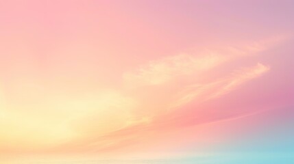 Fototapeta premium Soft pastel hues of pink and yellow blend seamlessly in the sky, with delicate clouds at sunrise.