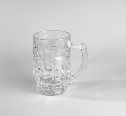 Empty beer glass on a white background. Crystal beer mug.