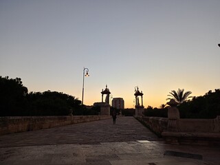 silhouette of a person walking on the sunset