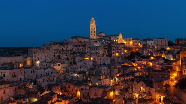 Matera Italy timelapse - old stone houses and caves on a hill at sunset or sunrise. Skyline time lapse of historical village (town) and UNESCO heritage in Europe in the evening (night) or morning.