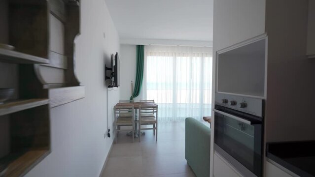 Modern apartment interior tour showcasing sea view, kitchen, living space, upscale amenities in high-demand coastal region