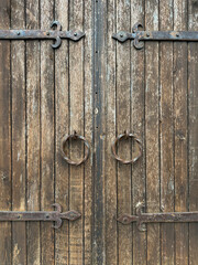 old wooden door with rusty iron handles