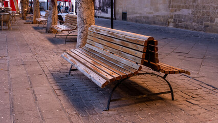 lonely bench on a busy street of the old town