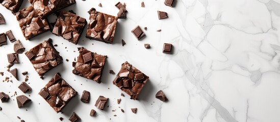 Chocolate brownies and chocolates on the kitchen white marble countertop, Top-down shot, ambient lighting, mockup