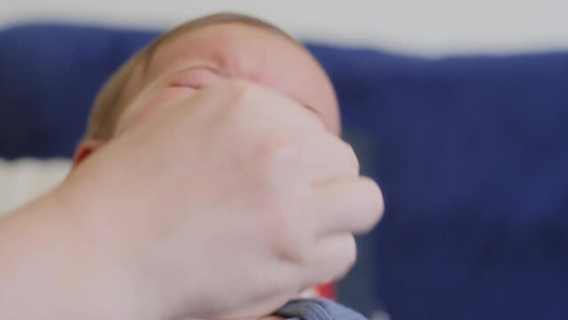 Mom wipes boogers from her baby's nose