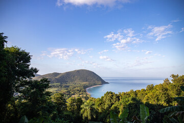 Guadeloupe, a Caribbean island in the French Antilles. View of the sandy beach of Guadeloupe. Caribbean vacation landscape. Grande Anse beach on the island of Basse-Terre. A secluded bay.