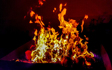 Fire and flames on barbecue in the dark Maldives.