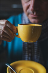 Adult mature man drinking tea and looking outside the windows at home
