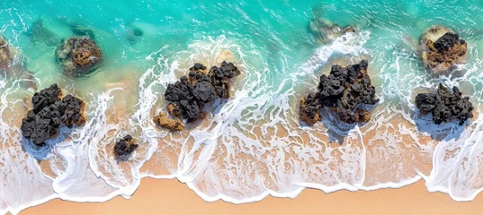 Foto op Canvas Aerial drone view of waves hitting rocks on turquoise ocean shore under clear skies © Ilja