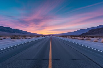 A lone highway heading straight into a breathtaking sunrise, with the desert sky painted in pastel...