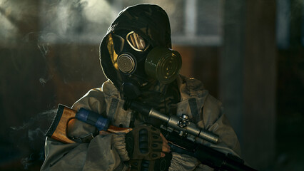 portrait of a soldier in a gas mask and a gun