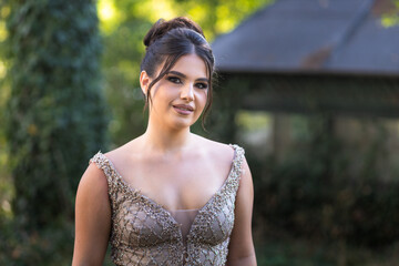 Close up portrait of a teen brunette girl in a golden dress. Ready for prom © stivog