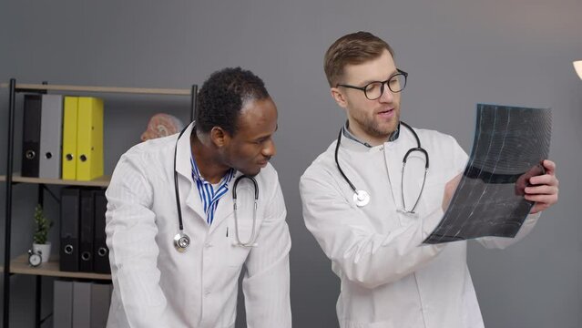 Two Doctors Reviewing Patients Medical Report X-ray image