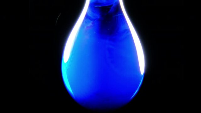 Prussian blue precipitate forms in a water drop and covers the surface in a blue sheet held up by surface tension 