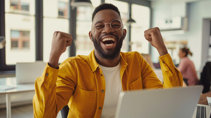 Naklejka premium Happy office worker, bright and airy office space, casual attire, sitting at a desk with a laptop, feeling accomplished and content