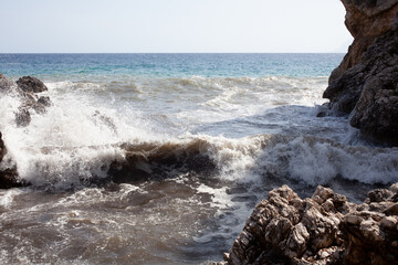 Large waves breaking over rocks - 738921466