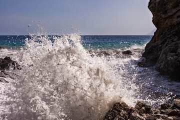 Large waves breaking over rocks - 738921890
