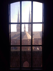Window in the dark with a Church view and sunny day
