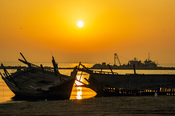 A broken old wooden fishing boat abandoned at Dammam Corniche, Kingdom of Saudi Arabia.