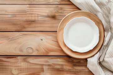 Eco-friendly table setting design. White plate and linen napkin on a light wooden table. dishes made from environmentally friendly materials.