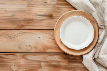 Fototapeta na wymiar Eco-friendly table setting design. White plate and linen napkin on a light wooden table. dishes made from environmentally friendly materials.