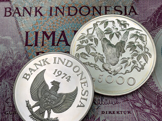Ancient Indonesian coins commemorating Indonesian animals 5000 rupiah on the background of ancient...