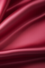 Beautiful background luxury cloth with drapery and wavy folds of burgundy red color creased smooth silk satin material texture. Abstract monochrome luxurious fabric background