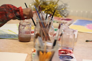 Children paint with pencel and paint. Art in preschool.