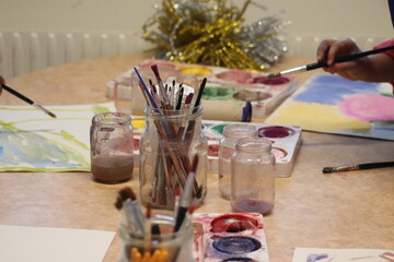 Children paint with pencel and paint. Art in preschool.