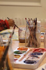 Children paint with pencel and paint. Art in preschool.