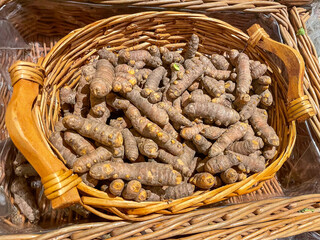 fresh turmeric in a wooden basket ,supermarket